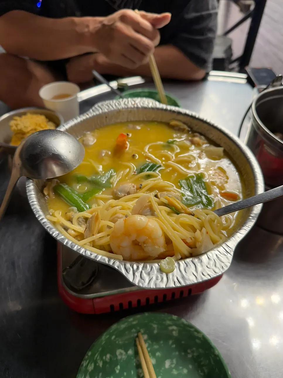 Clam broth for vongole soju stew, cooked at the table