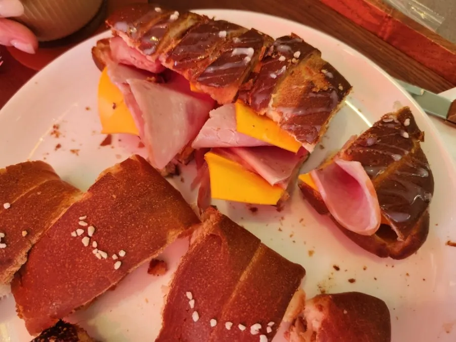 Half-eaten ham cheese salt bread and salt bread