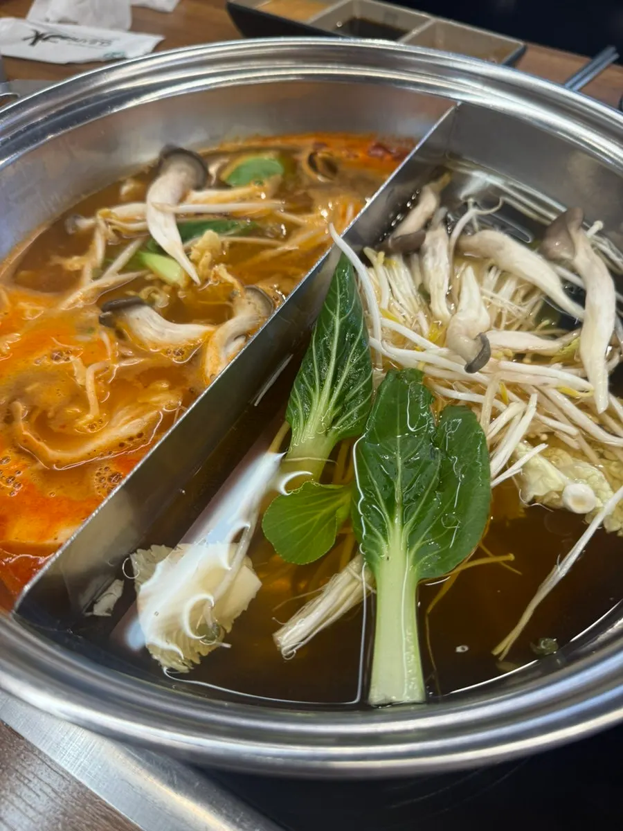 Vegetables and meat simmering in the shabu-shabu broth
