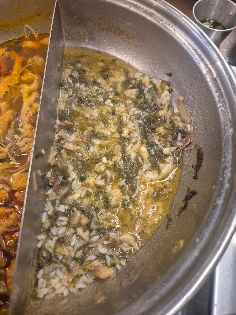 Fried tofu added to spicy mushroom broth