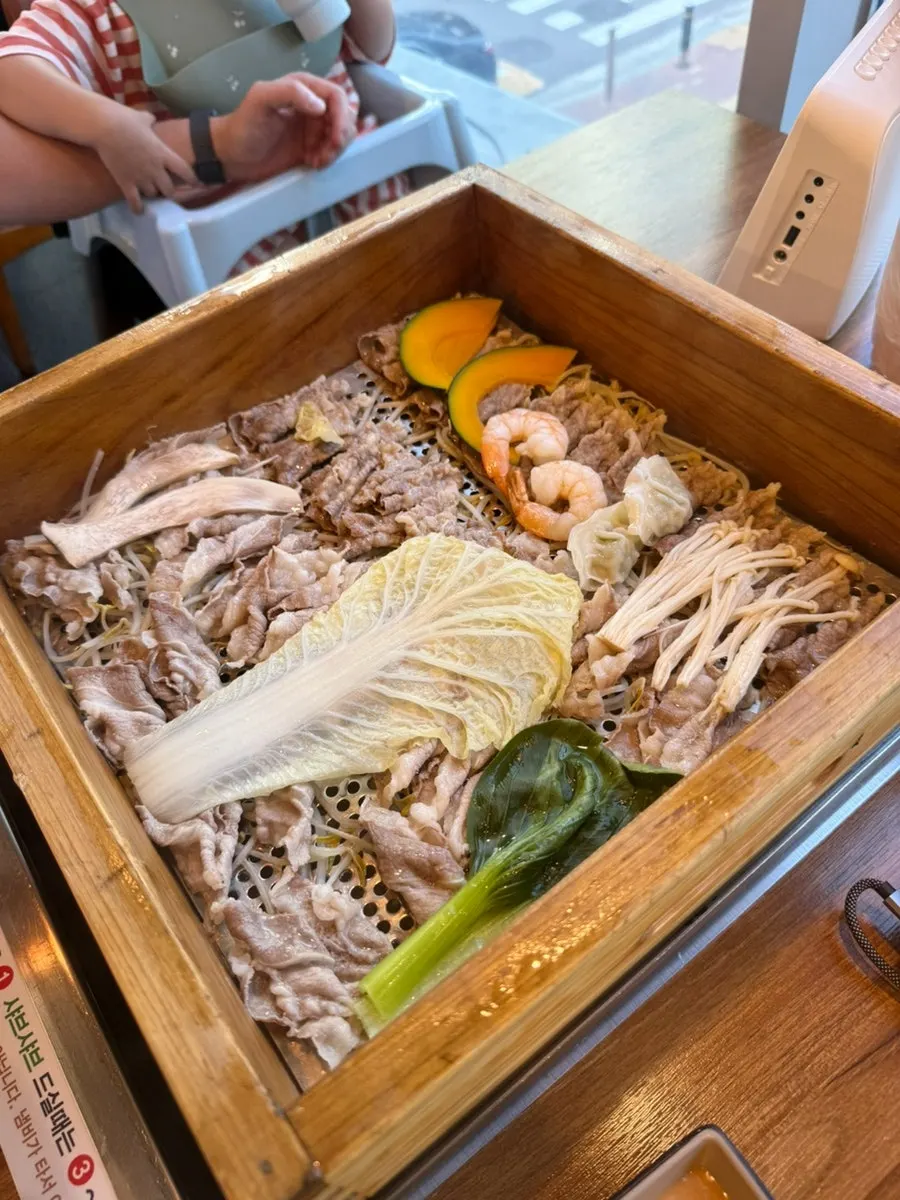 Meat and vegetables cooked in the cypress steamer