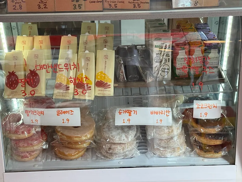 Dessert display case with financiers and egg tarts