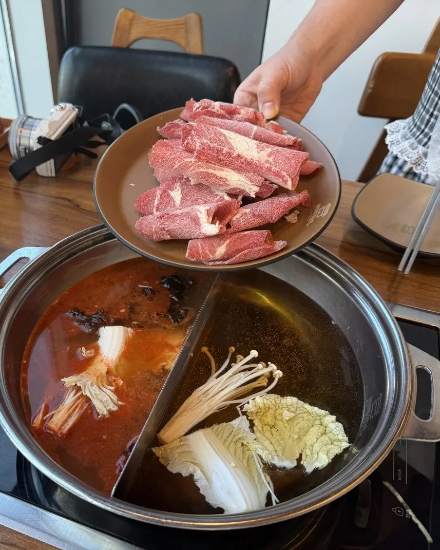 Shabu-shabu table setting with two broths