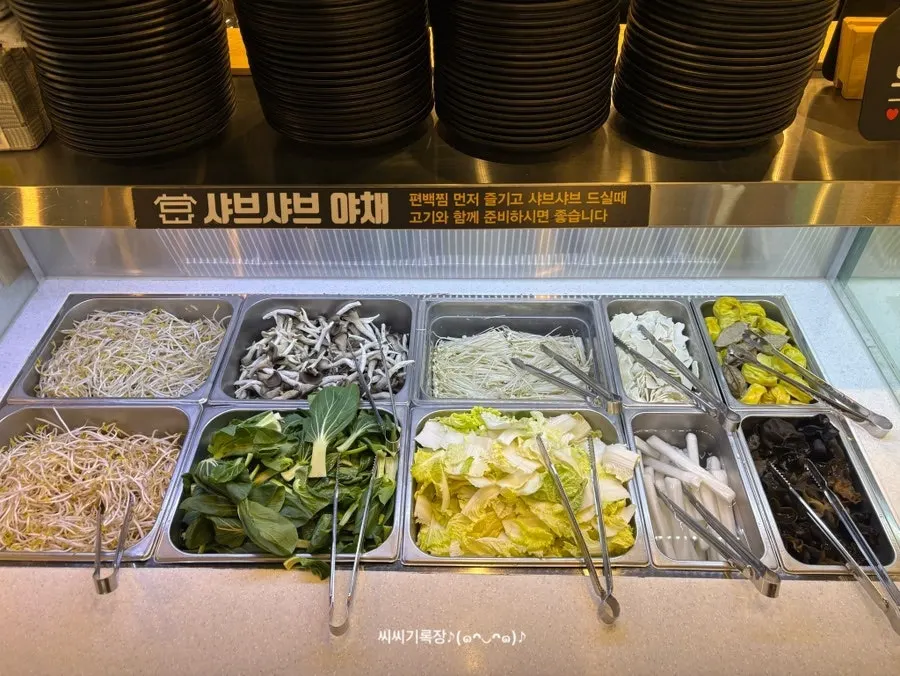 Shabu-shabu vegetables and sauces on the self-serve bar