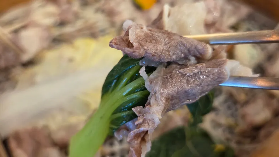 Meat cooked one slice at a time in the shabu-shabu