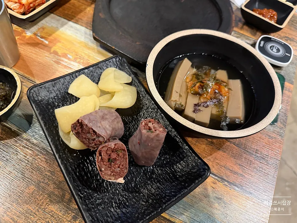 Side dish spread with sujebi, sundae, and muksabal