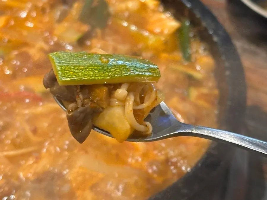 Gopchang jeongol topped with chadolbagi and enoki mushrooms