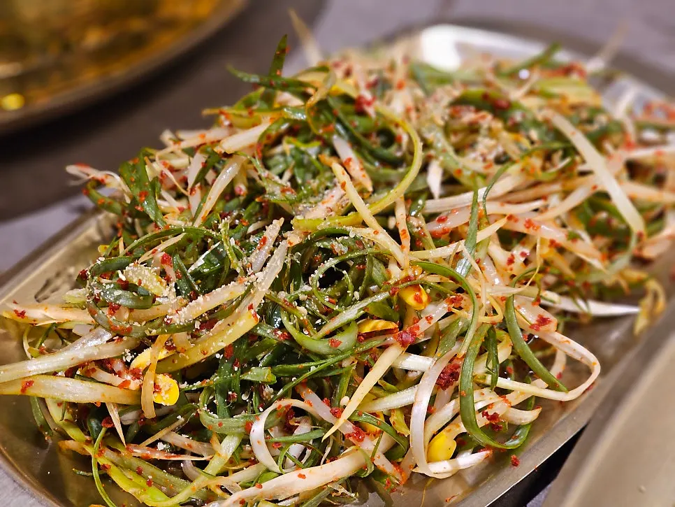 Banchan served in brass bowls