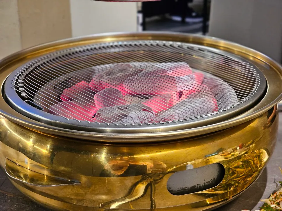Portable charcoal brazier and grill plate on the table