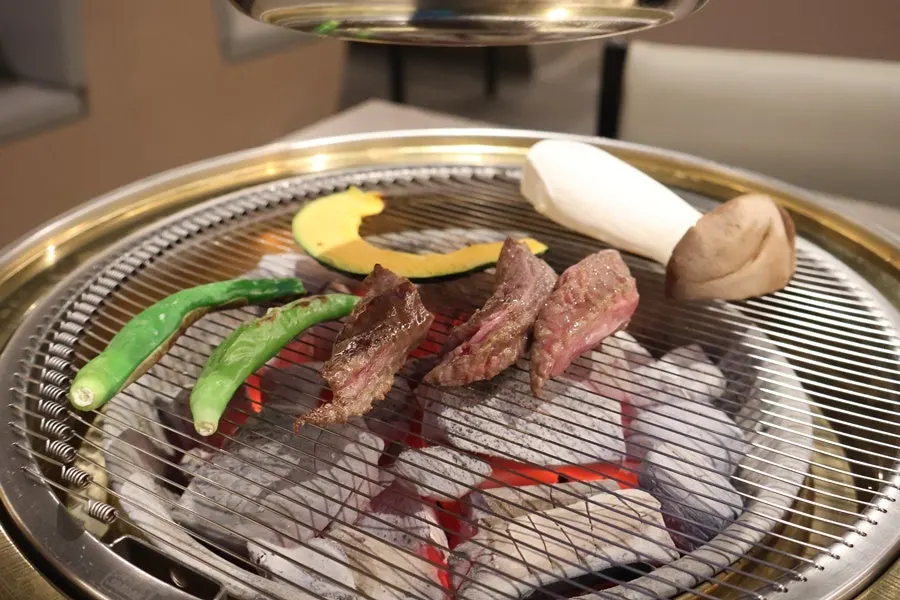 Hanwoo cooking over the charcoal grill