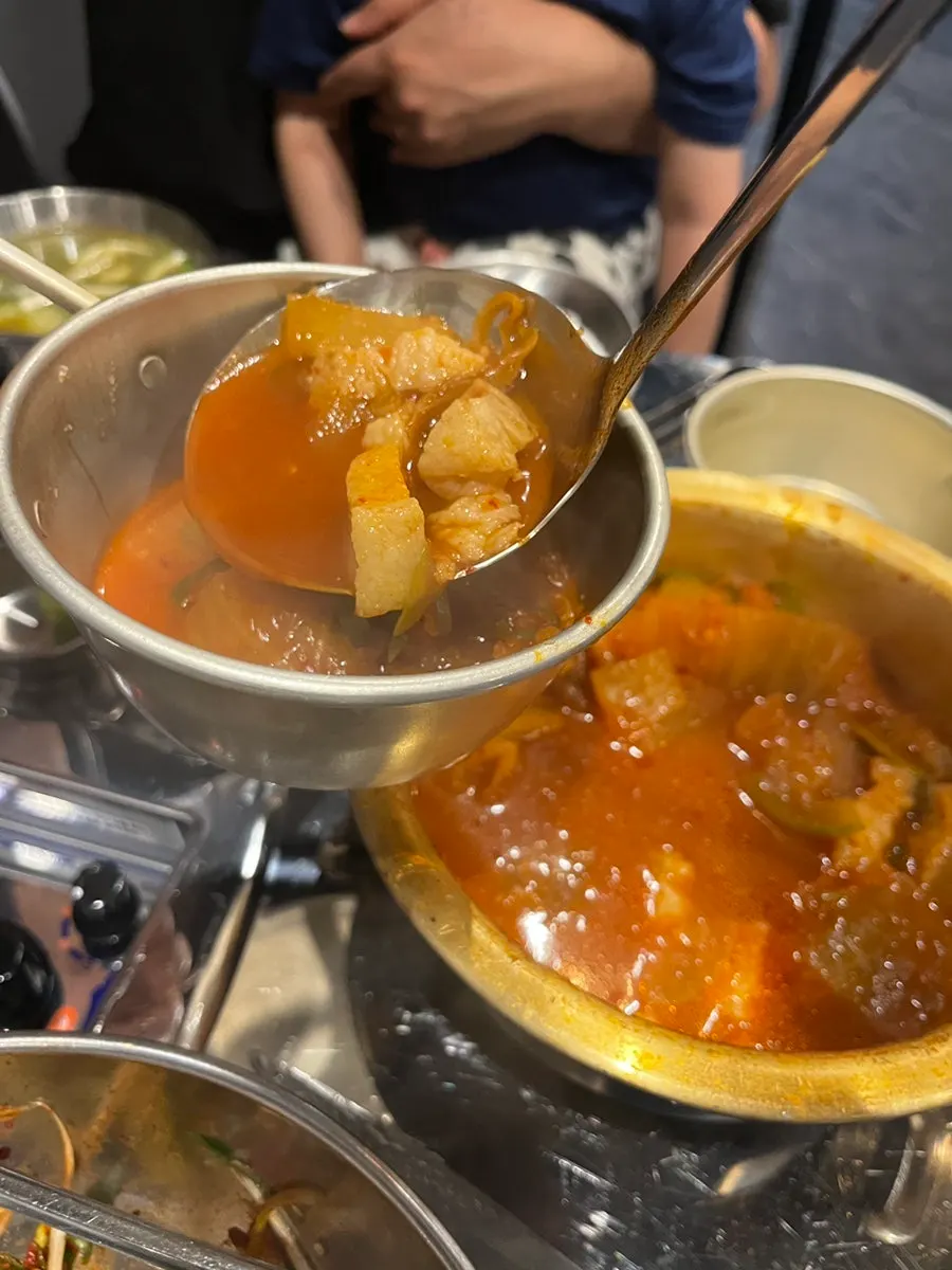 Kimchi stew broth with large chunks of beef