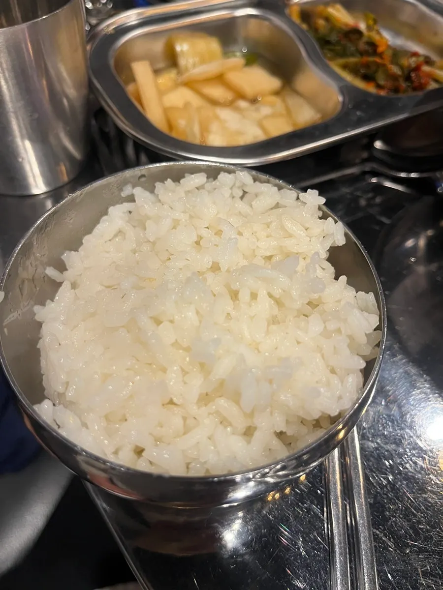A spoonful of kimchi stew being scooped up