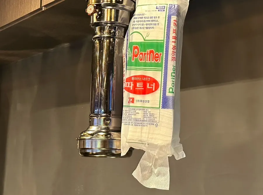 Old-fashioned tissue holder hanging from the ceiling
