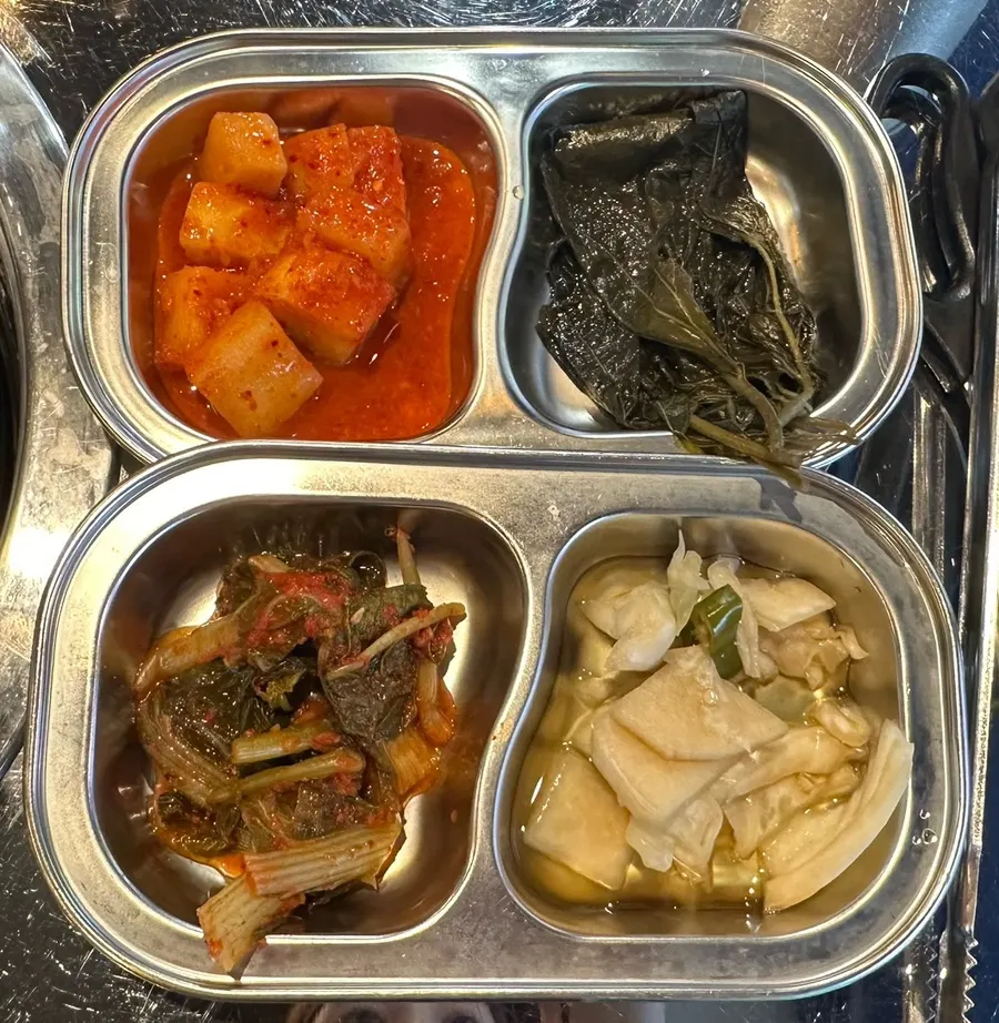 Plate of jangajji and seasoned perilla leaves among other side dishes