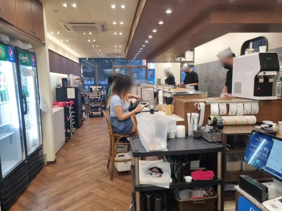 Conveyor-belt sushi seating almost fully occupied