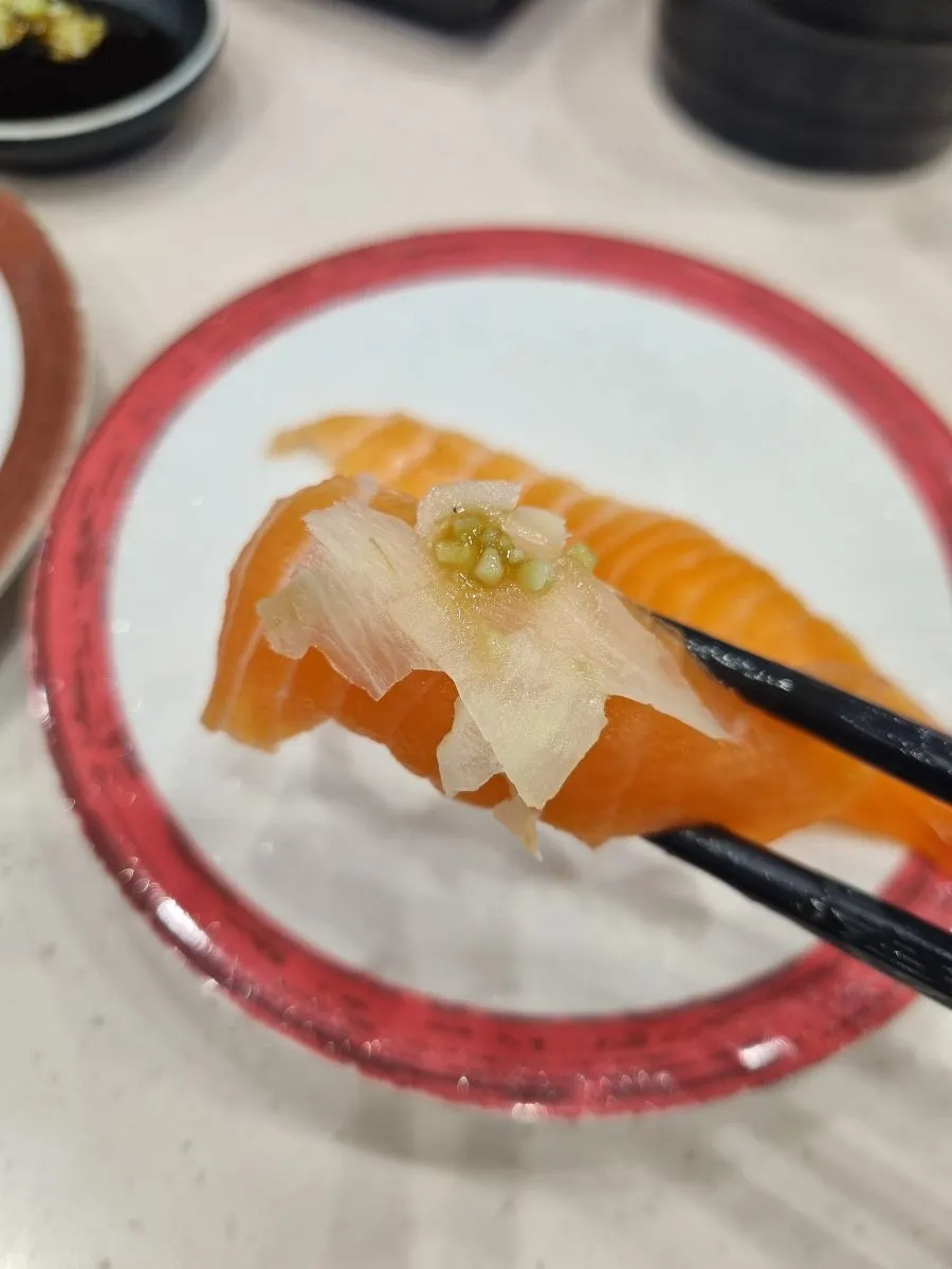 Picking up a piece of salmon sushi