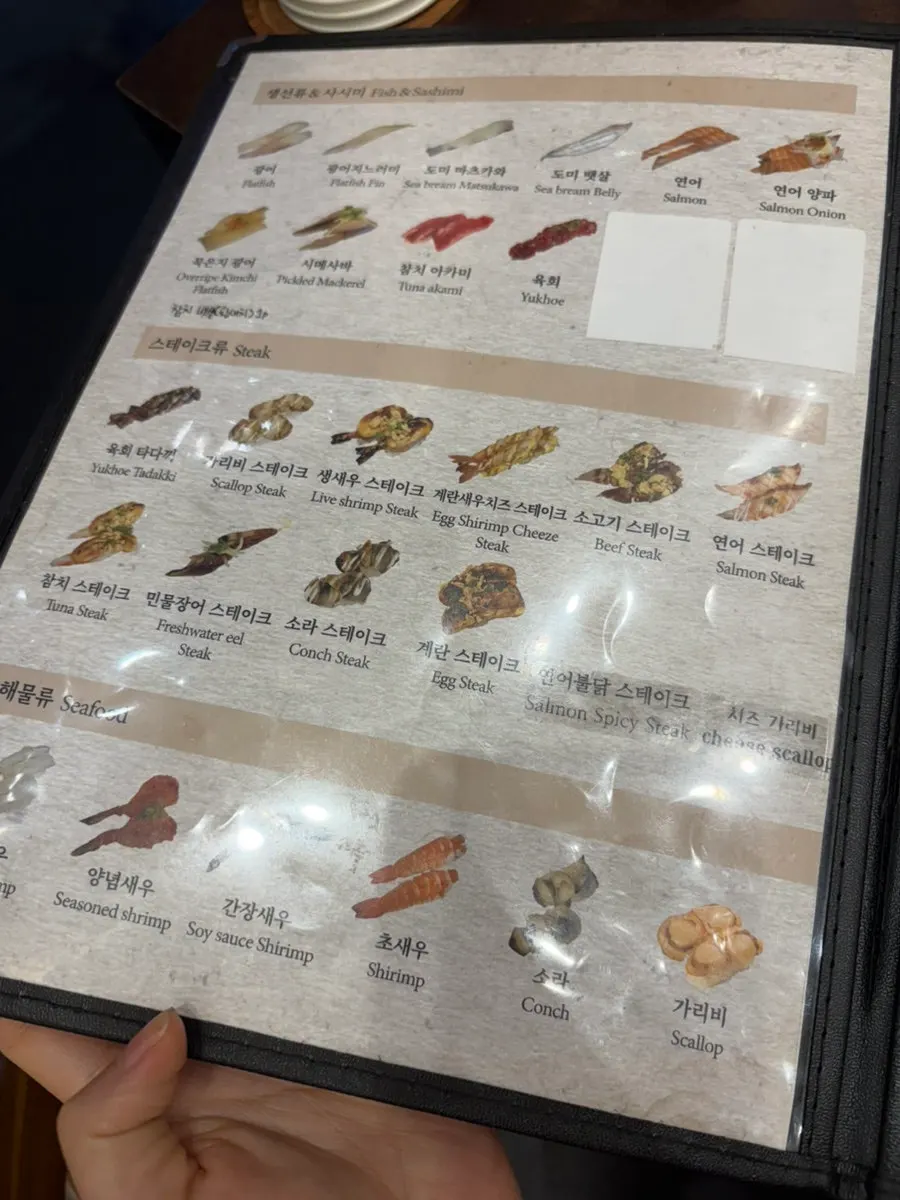 Choosing sushi from photos on the tablet menu