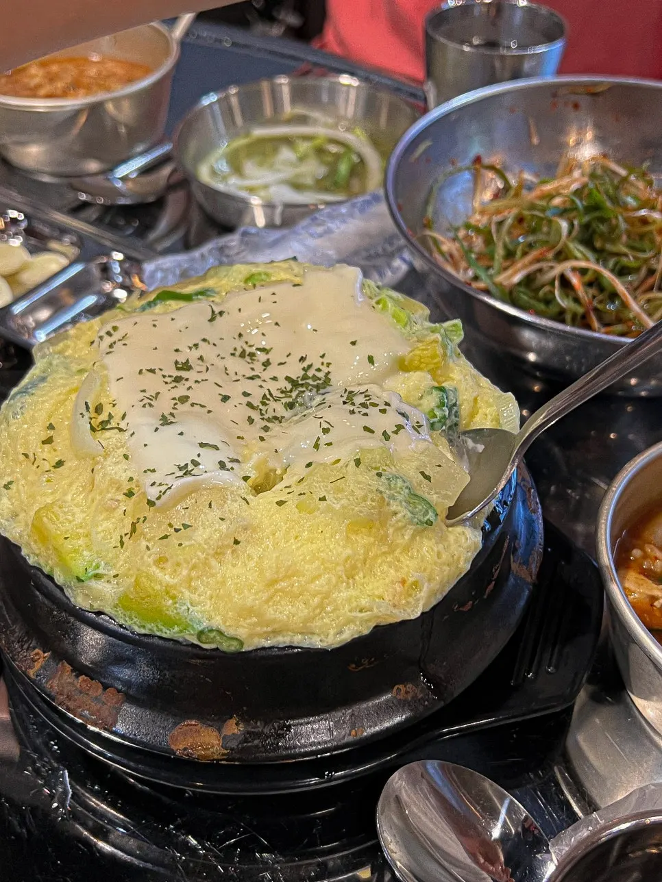 A spoonful of steamed egg loaded with cheese