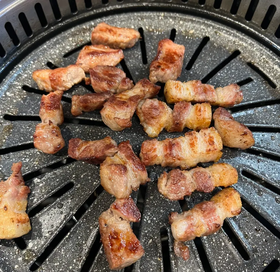 Samgyeopsal and moksal cooking on the grill