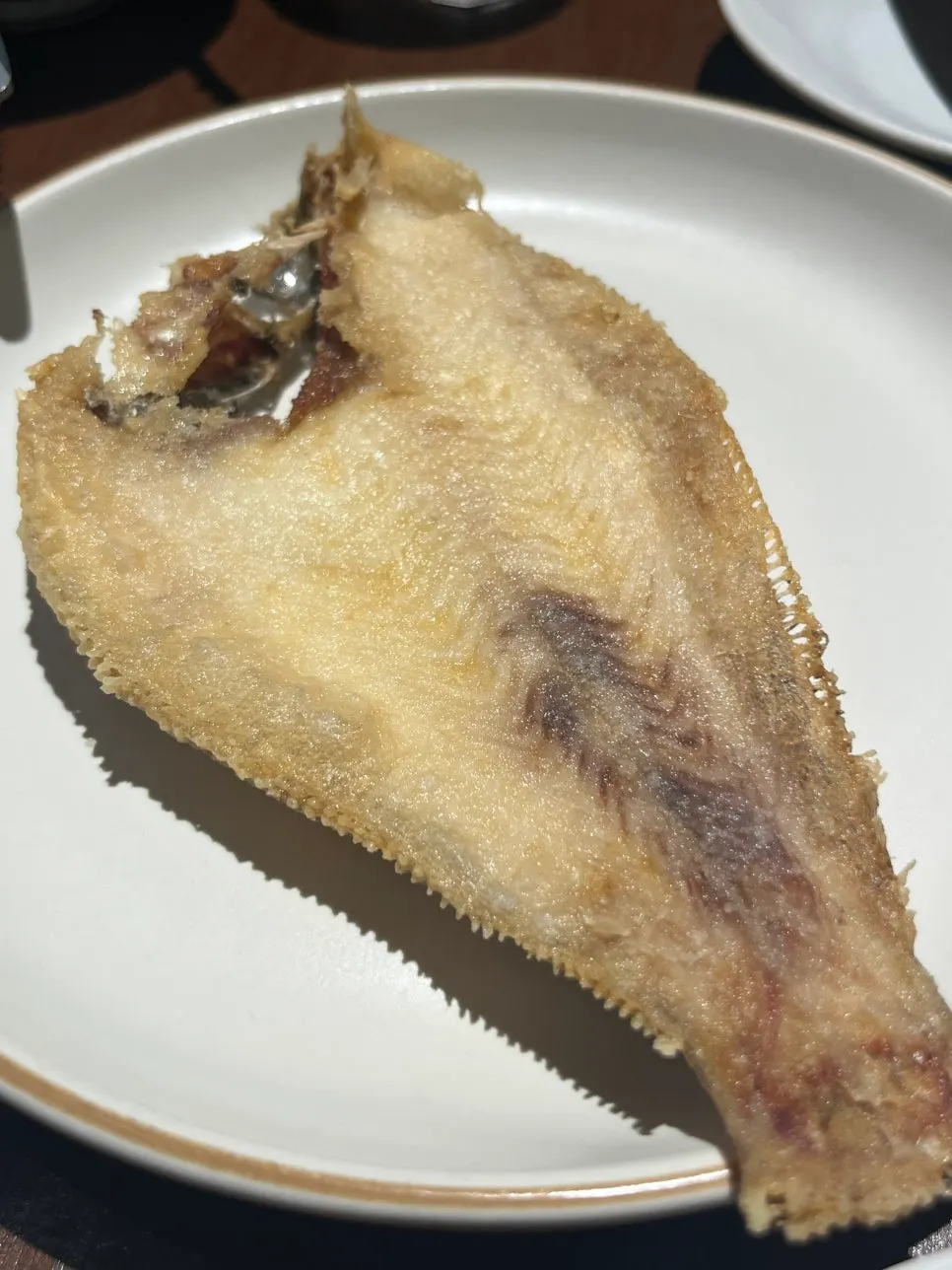 Small grilled fish served as a complimentary side dish