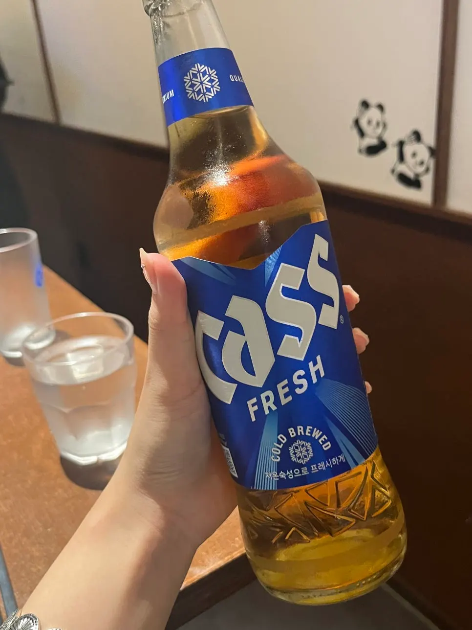 Complimentary grilled fish side dish with a glass of beer
