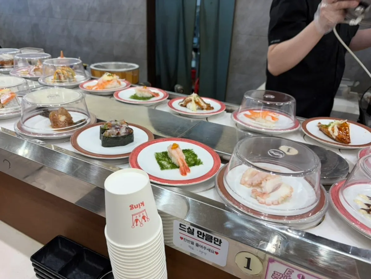 View of the sushi rail in front of the kitchen where chefs prepare sushi