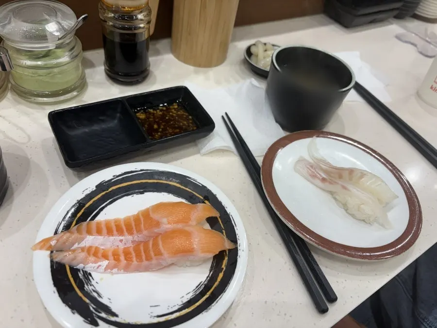 Plate of salmon sushi on the conveyor belt