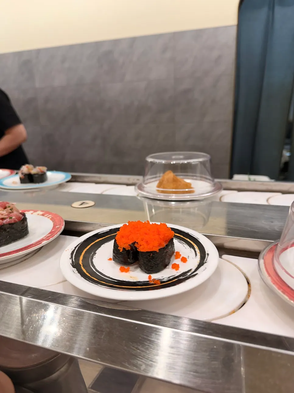 Conveyor-belt sushi plates going around the rail
