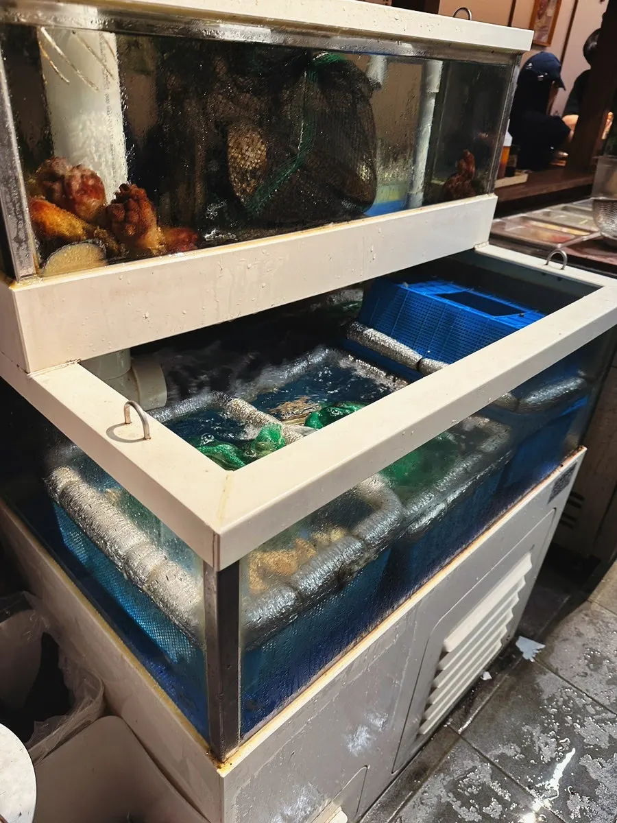 Susan Jang entrance with a fish tank and standing sign
