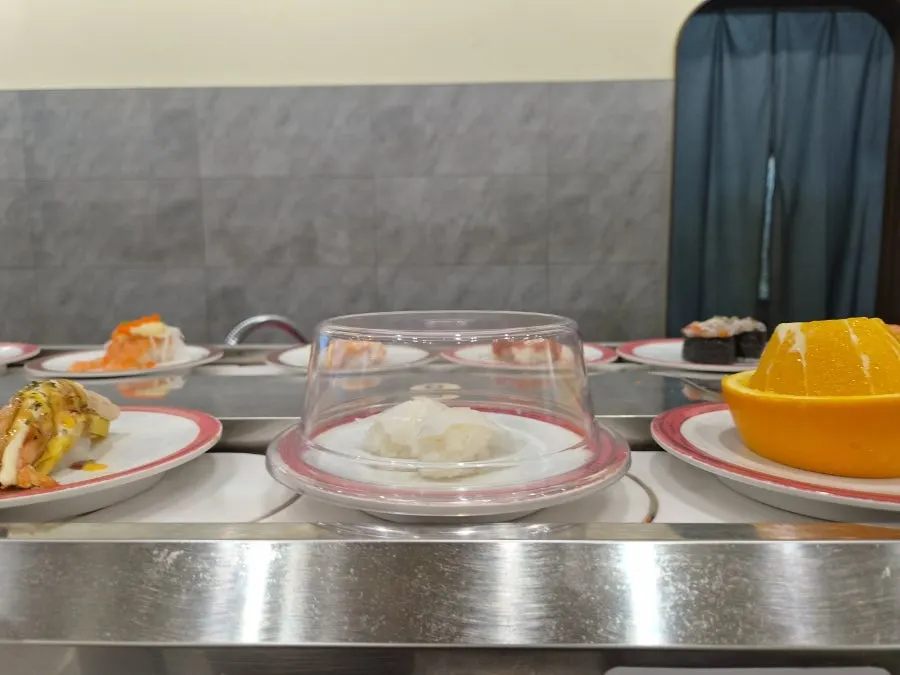 Sushi circling on the conveyor belt with bar seats