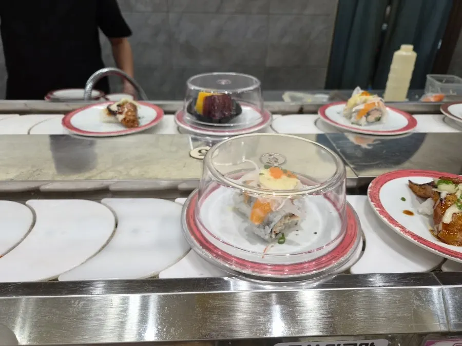 Conveyor belt fully stocked with sushi