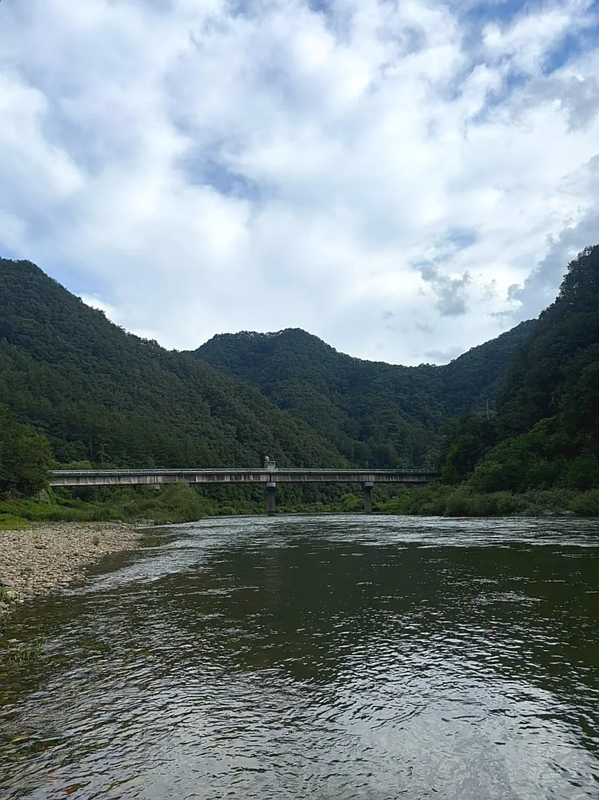 Enjoying the Pyeongchang River shore with feet in the water