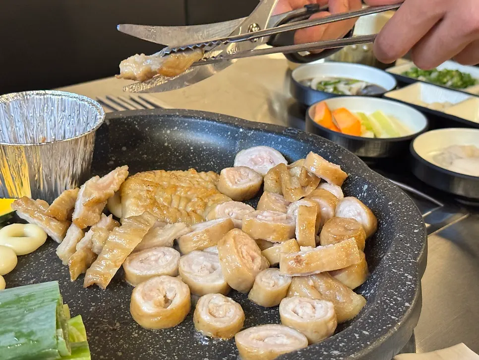 Par-grilled makchang cooking on the grill