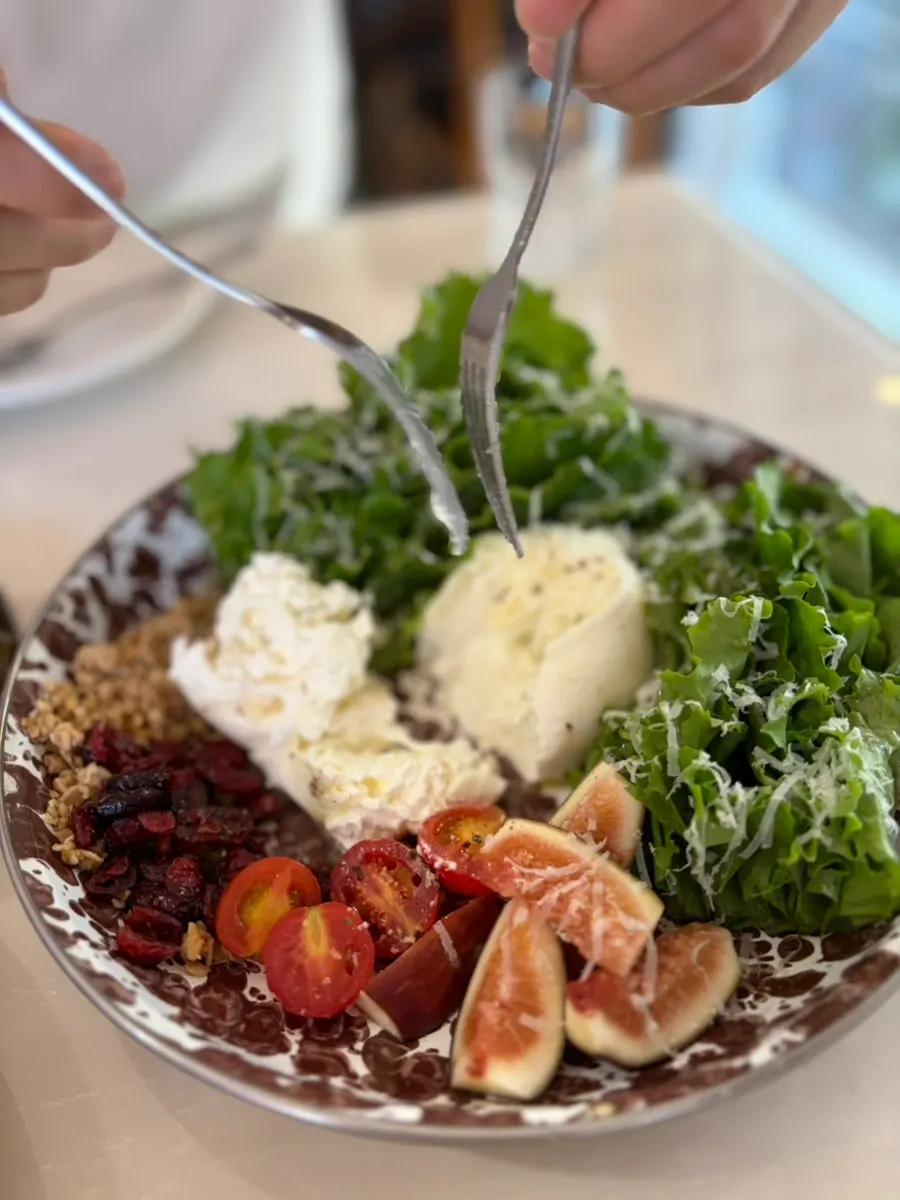 Close-up of burrata cheese salad topped with figs
