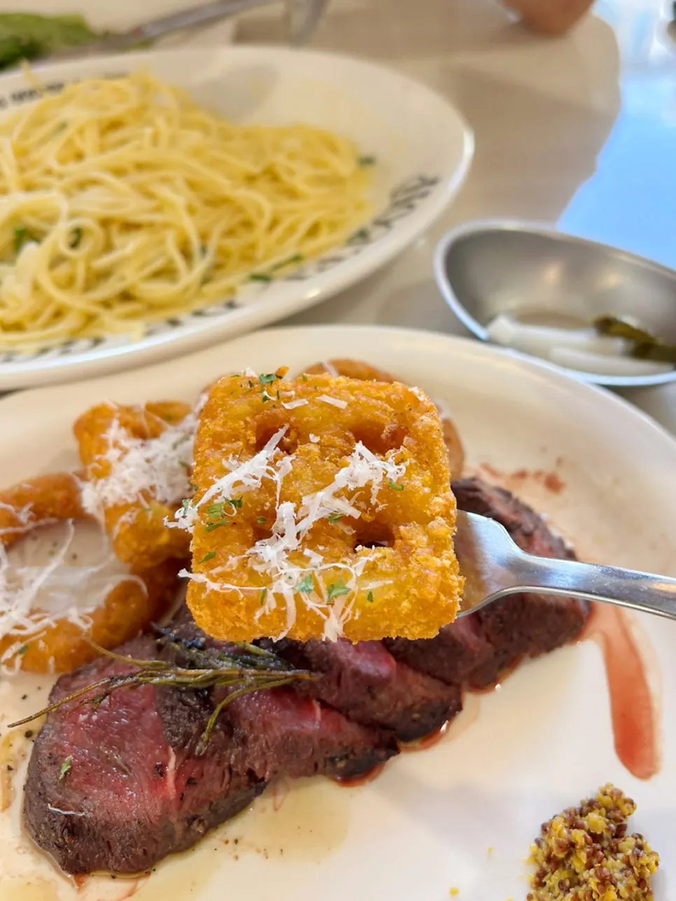 A piece of steak topped with whole grain mustard