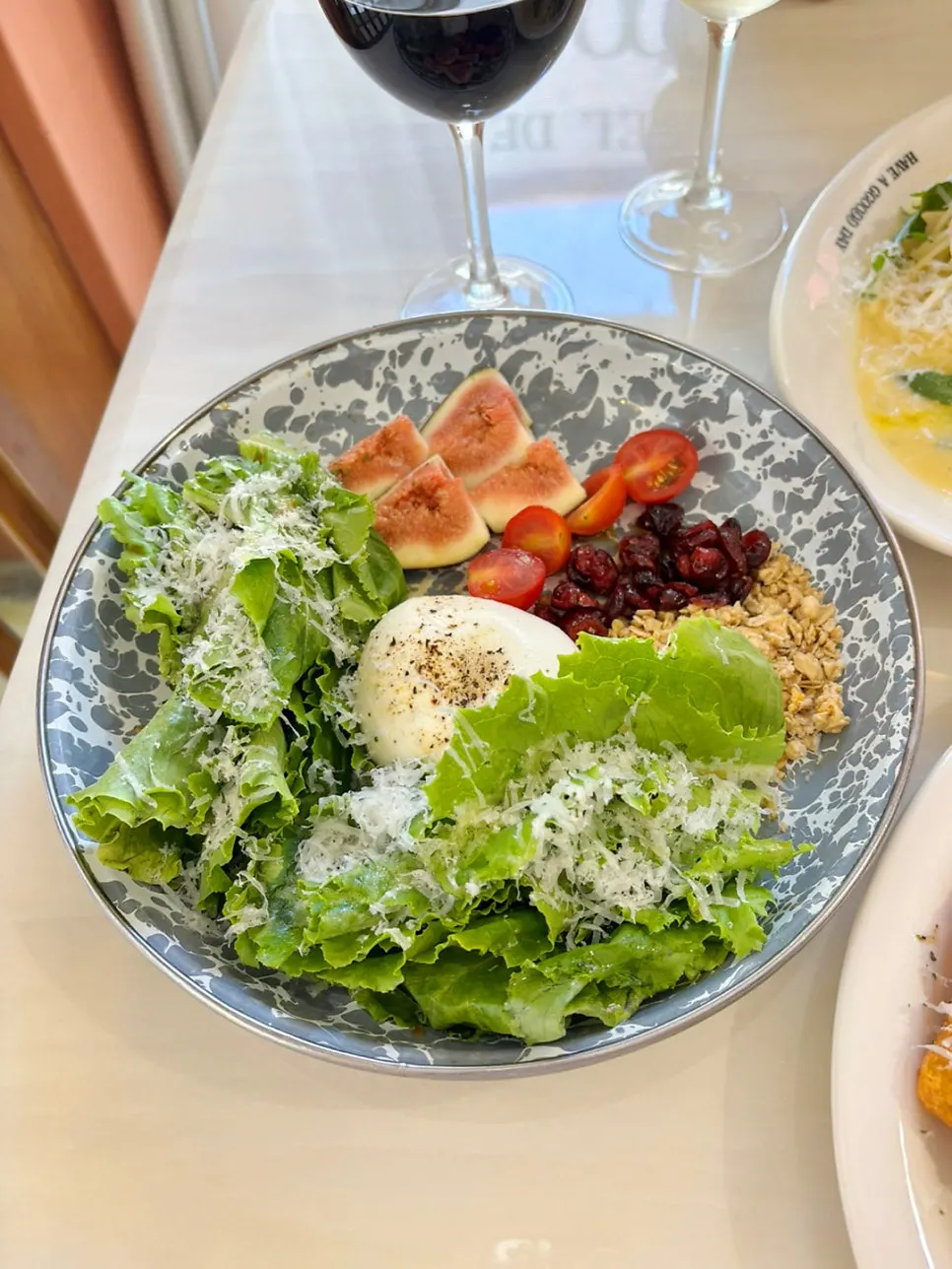 A plate of burrata seasonal fruit salad