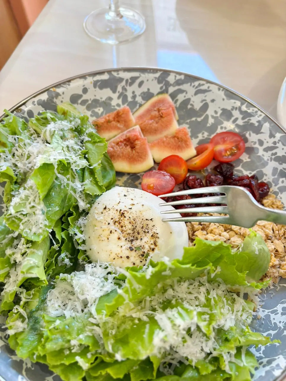 A generous ball of burrata cheese on the salad