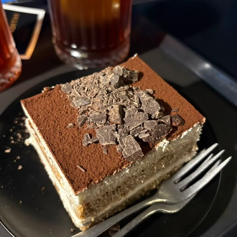 Cross-section of the moist tiramisu cream alongside coffee