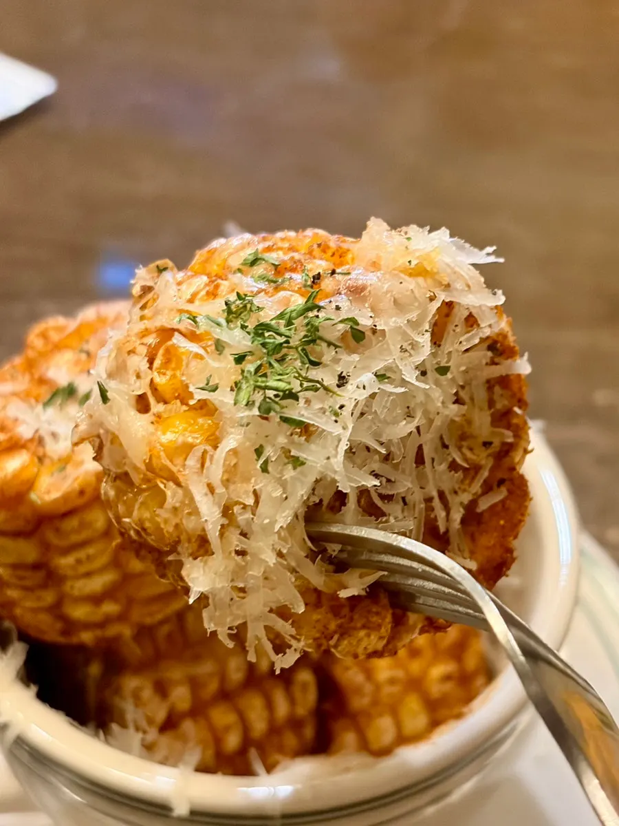 A corn rib piece held up by hand