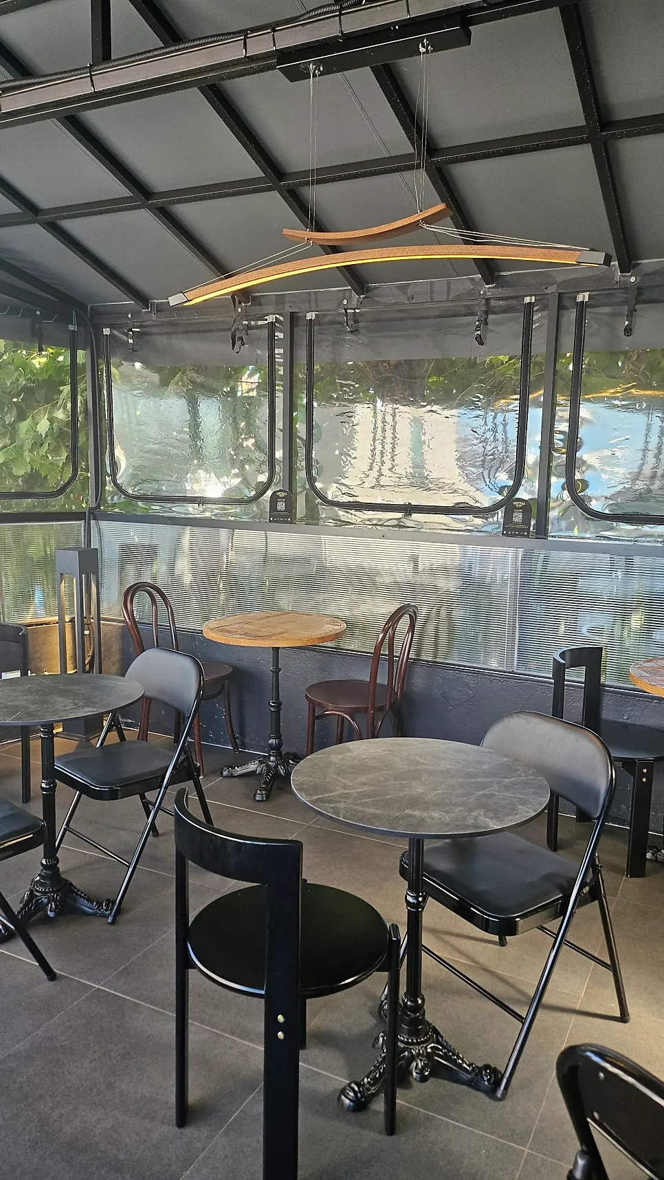 Street trees visible through the clear vinyl wall on the 3rd floor