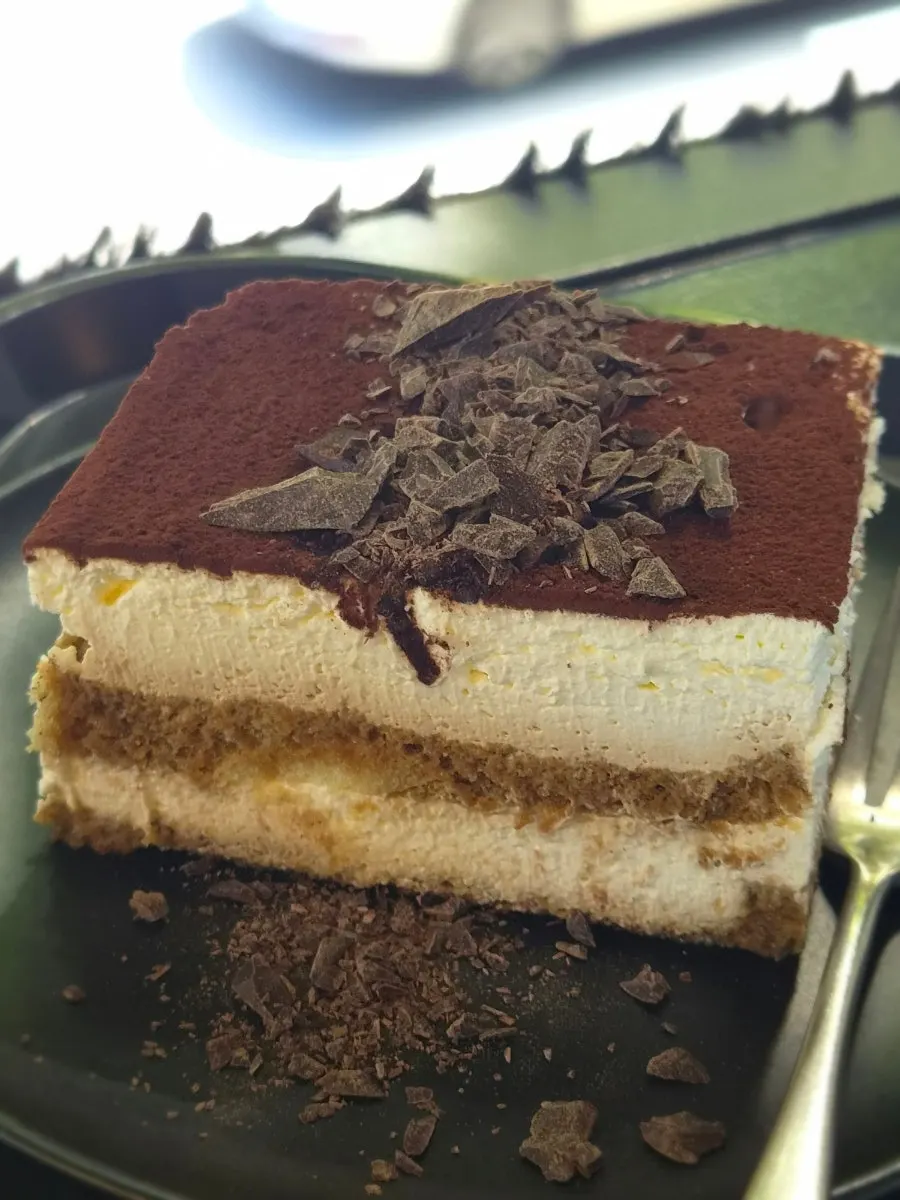 Cross-section of classic tiramisu with generous cream