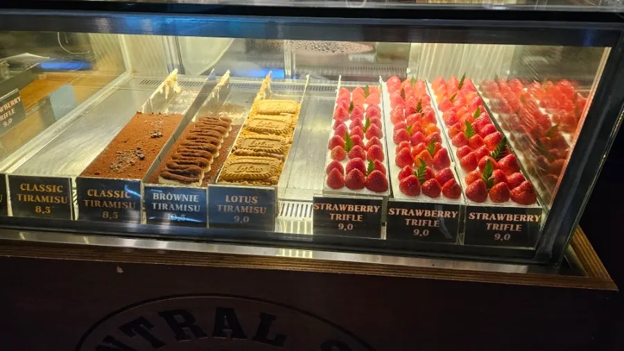 Menu board with brewing coffee and tiramisu