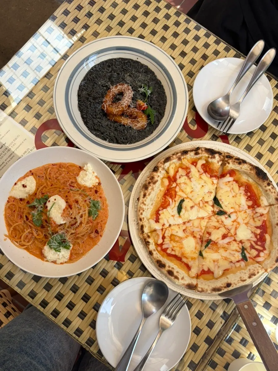 Table with leftover pasta and pizza