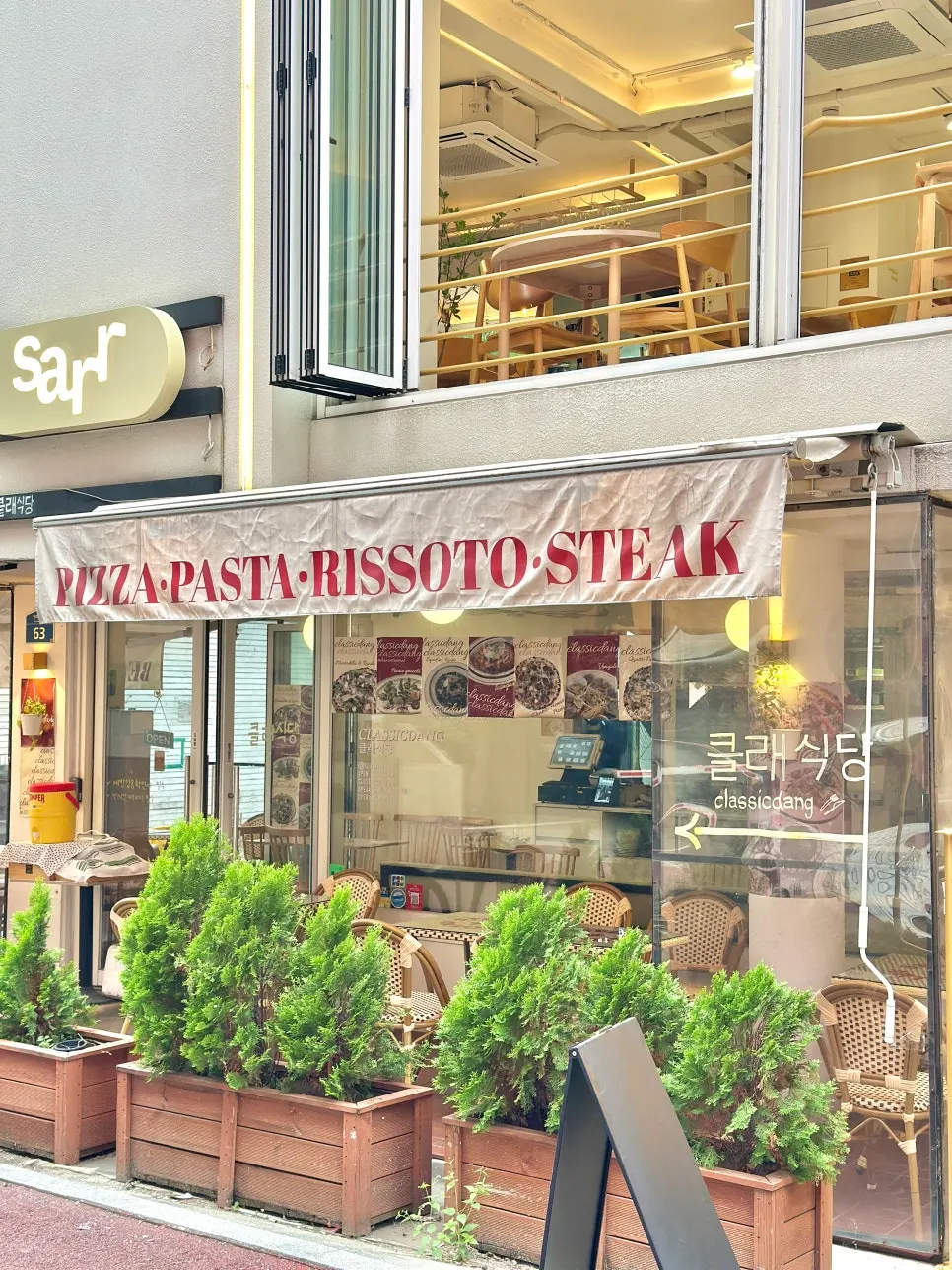 Rattan chairs and outdoor tables in front of Classicdang's entrance