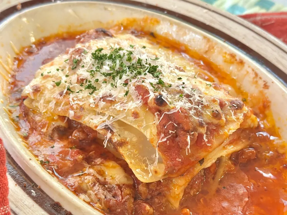 Cross-section of lasagna layered with tomato sauce and cheese