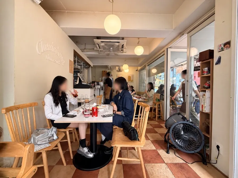 Wood-tone tables and checkered floor inside Classicdang