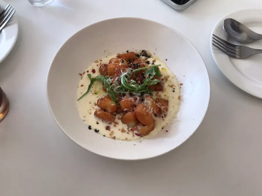 Shrimp aglio e olio topped with shrimp and arugula
