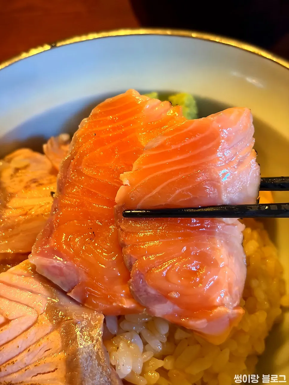 Close-up of the glossy, smoky-charred salmon rice bowl