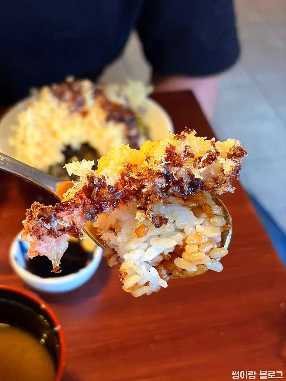 Tempura and rice drizzled with sauce in the tendon