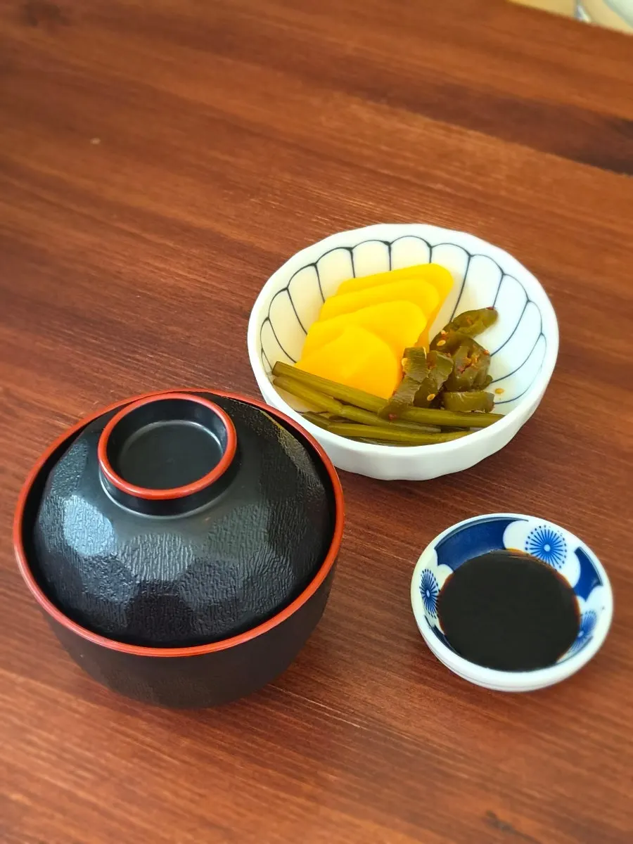 Basic banchan setup including pickled radish and garlic scapes